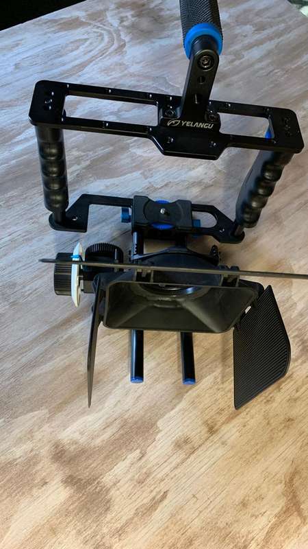 Universal Camera Cage Rig Kit with ND filter holder attached. Grip handles, cold shoe follow focus.