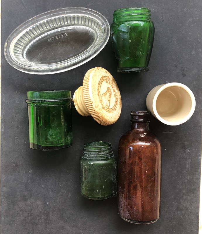 GREEN GLASS BOTTLES AND OTHER PORCELAN CLEAR GLASS AND STONEWARE A 7 PIECE COLLECTION