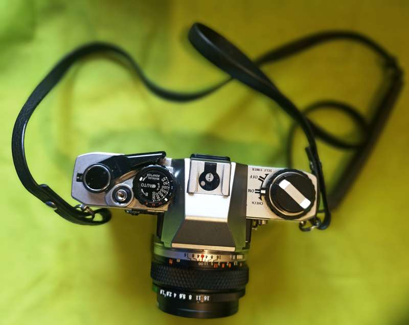 Olympus OM-10 camera with 50mm F 1.8 lens/light filters/lens cap/body cap/leather cover/manual