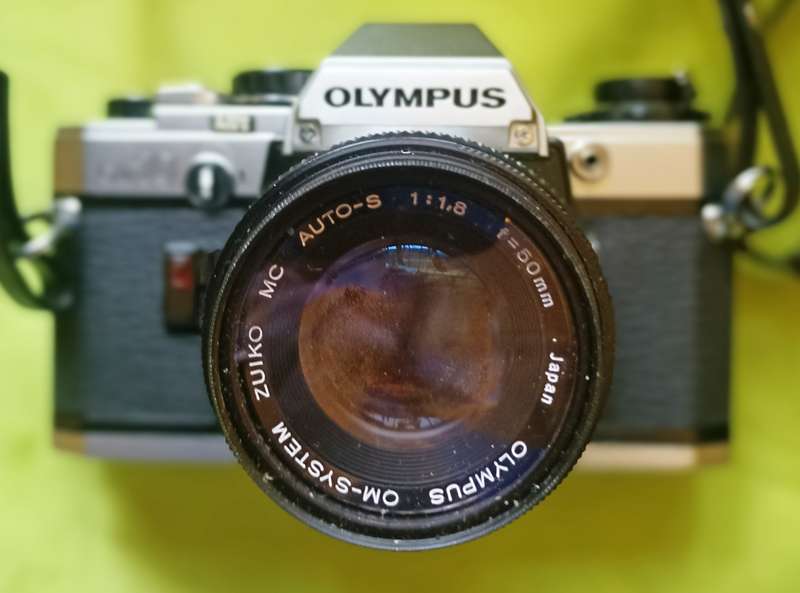 Olympus OM-10 camera with 50mm F 1.8 lens/light filters/lens cap/body cap/leather cover/manual