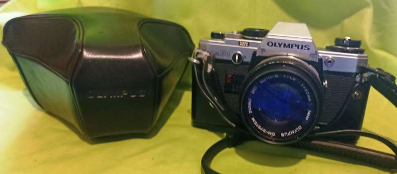 Olympus OM-10 camera with 50mm F 1.8 lens/light filters/lens cap/body cap/leather cover/manual
