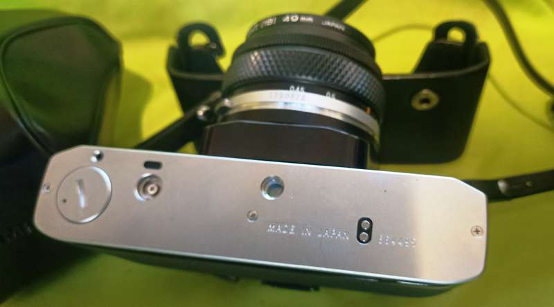 Olympus OM-10 camera with 50mm F 1.8 lens/light filters/lens cap/body cap/leather cover/manual