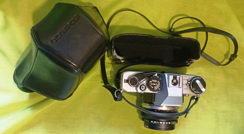 Olympus OM-10 camera with 50mm F 1.8 lens/light filters/lens cap/body cap/leather cover/manual