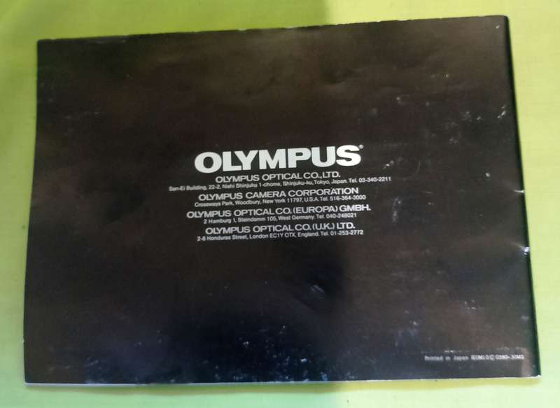 Olympus OM-10 camera with 50mm F 1.8 lens/light filters/lens cap/body cap/leather cover/manual