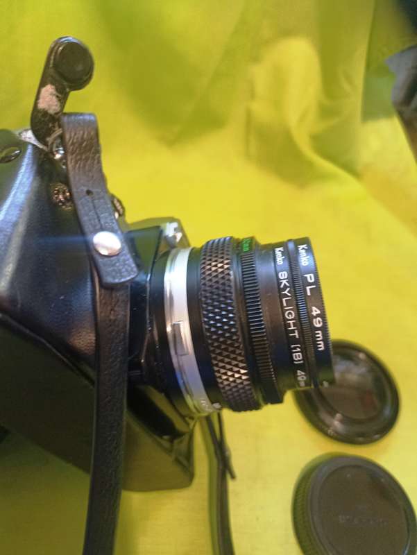 Olympus OM-10 camera with 50mm F 1.8 lens/light filters/lens cap/body cap/leather cover/manual