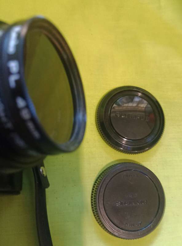 Olympus OM-10 camera with 50mm F 1.8 lens/light filters/lens cap/body cap/leather cover/manual