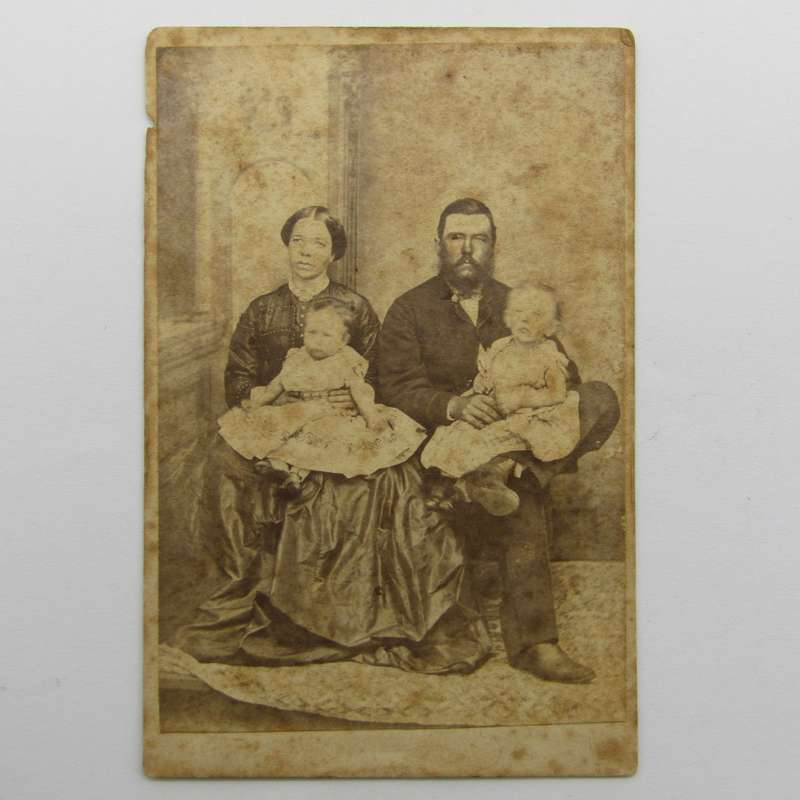 Antique photo of husband and wife with two children