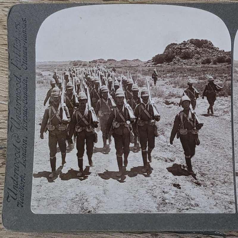 Boer War stereoscope card - Her Majesty's Heroes marching into Colesberg, S.A
