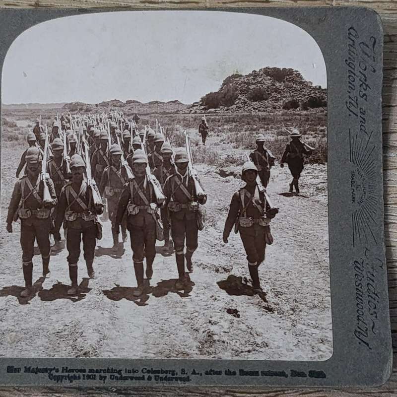 Boer War stereoscope card - Her Majesty's Heroes marching into Colesberg, S.A