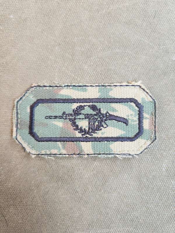 used (removed from uniform) SAP era sniper cloth field-dress badge on SAP 2nd patt camo backing