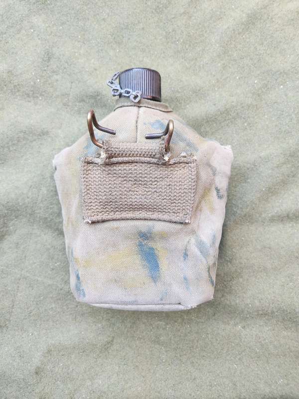 used original US Army dd 1945 canteen and cover with signs of Rhod era custom "baby-poop" camo paint