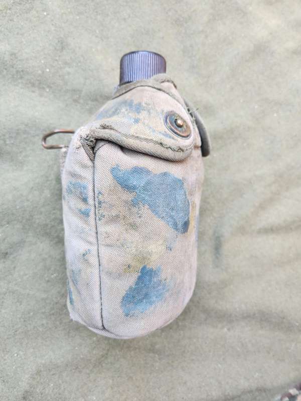 used original US Army dd 1945 canteen and cover with signs of Rhod era custom "baby-poop" camo paint