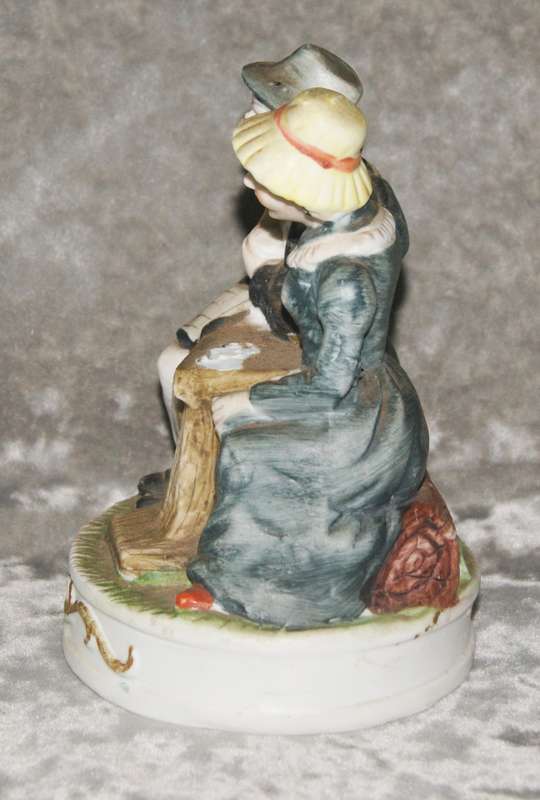Vintage porcelain statue of old man and woman