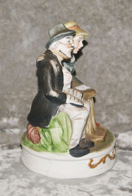 Vintage porcelain statue of old man and woman