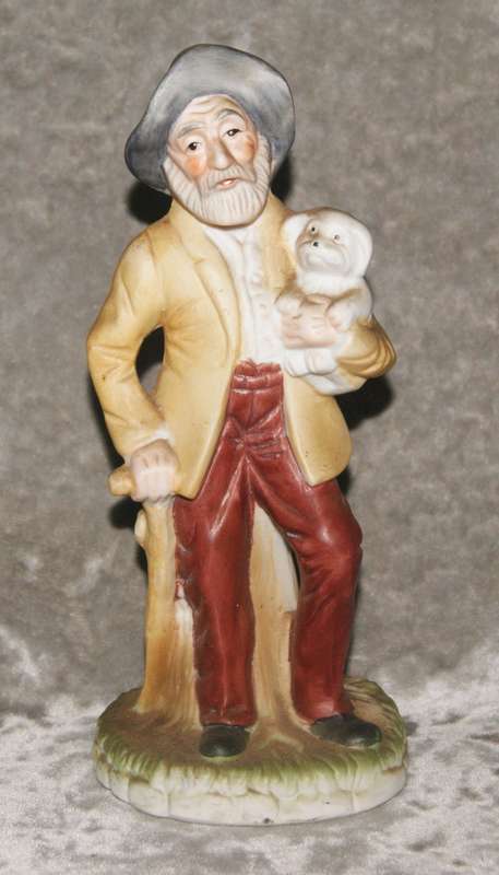 Vintage ceramic figurine of man holding dog