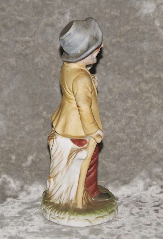Vintage ceramic figurine of man holding dog