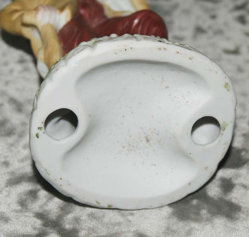 Vintage ceramic figurine of man holding dog