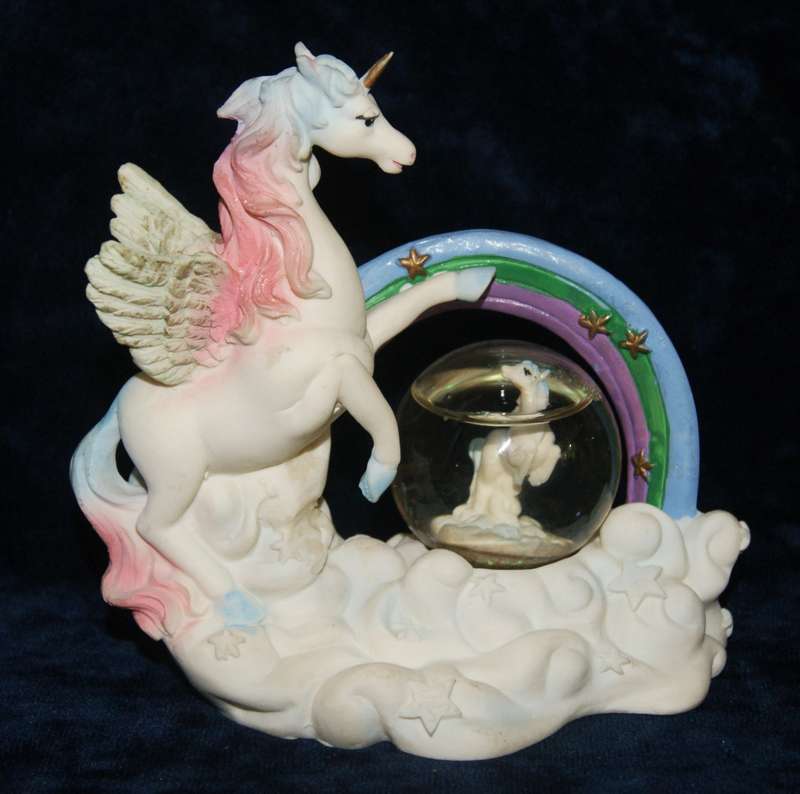 Rainbow unicorn with snow globe