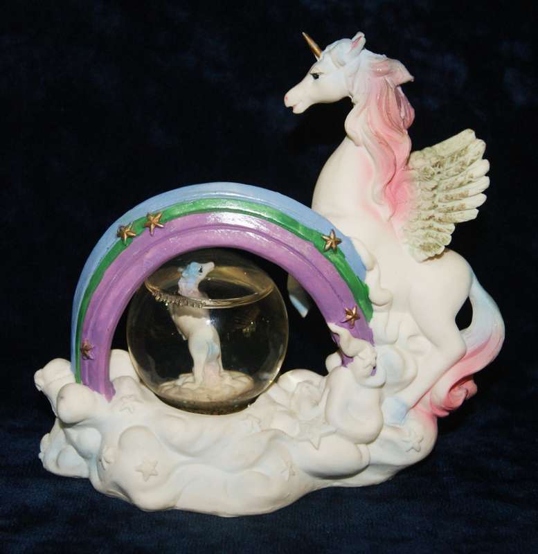 Rainbow unicorn with snow globe