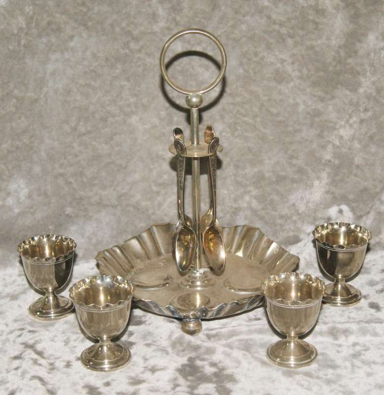 Antique EPNS egg and spoon set on holder (1 mismatched spoon)