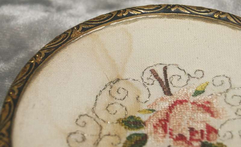 Brass footed pin dish with needlepoint under concave glass