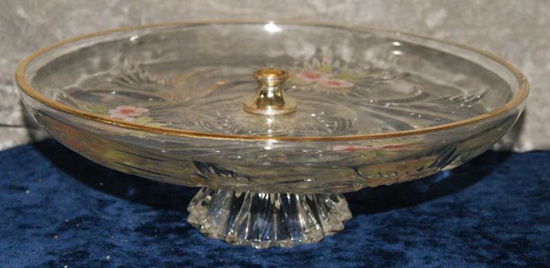 Molded glass pastry serving dish on central column with signed artwork on top