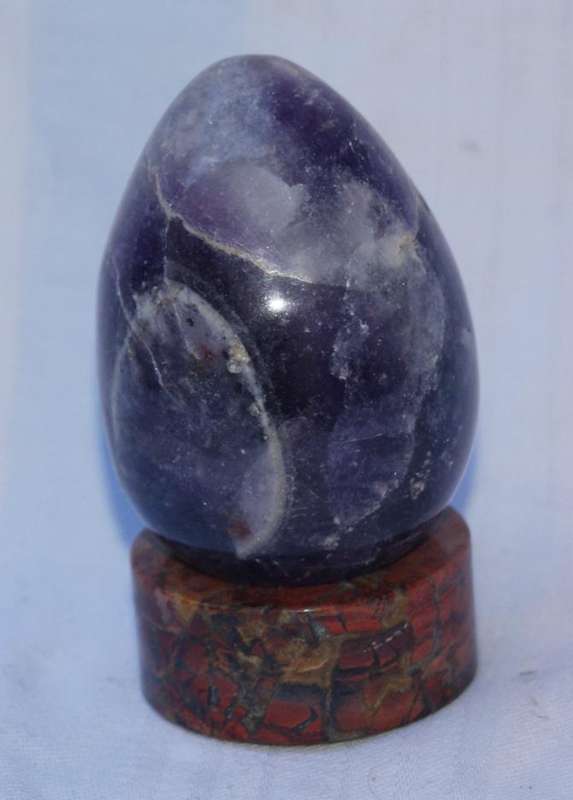 Polished Amethyst egg with brecciated Jasper stand