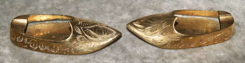 Pair of vintage brass etched shoes