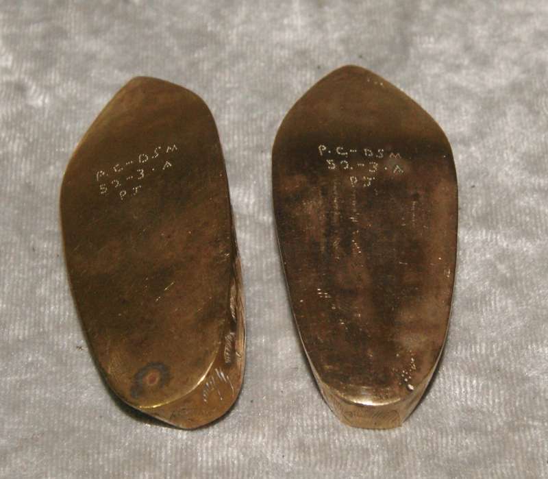 Pair of vintage brass etched shoes