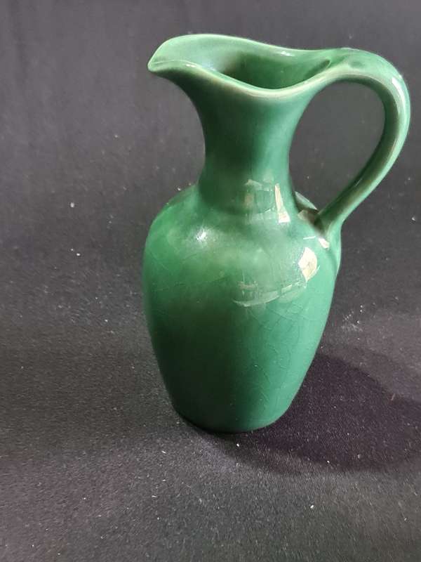 Three ashtrays one Delft and small green jug
