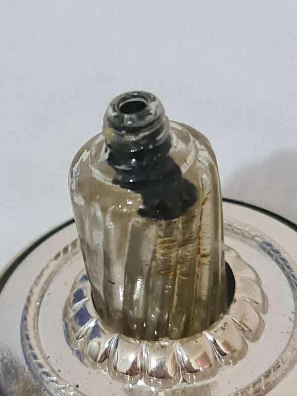 Clock that is not a clock. Small scent bottle inside.  Bottle no lid. Dial damage