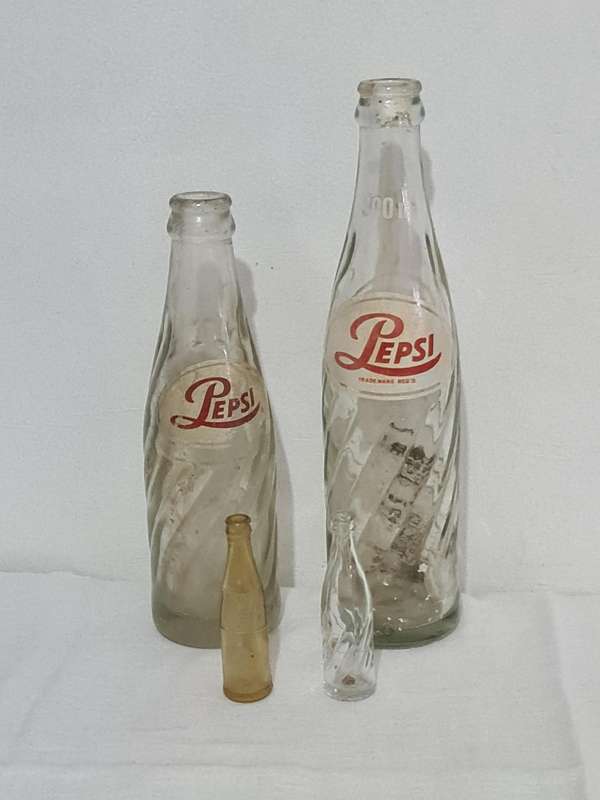 X4 Differant size and age Pepsi Cola bottles.