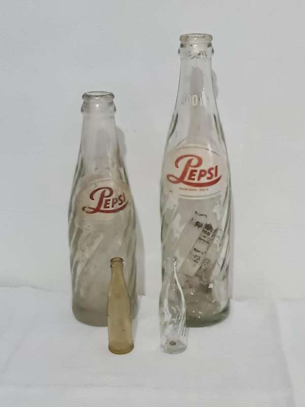 X4 Differant size and age Pepsi Cola bottles.