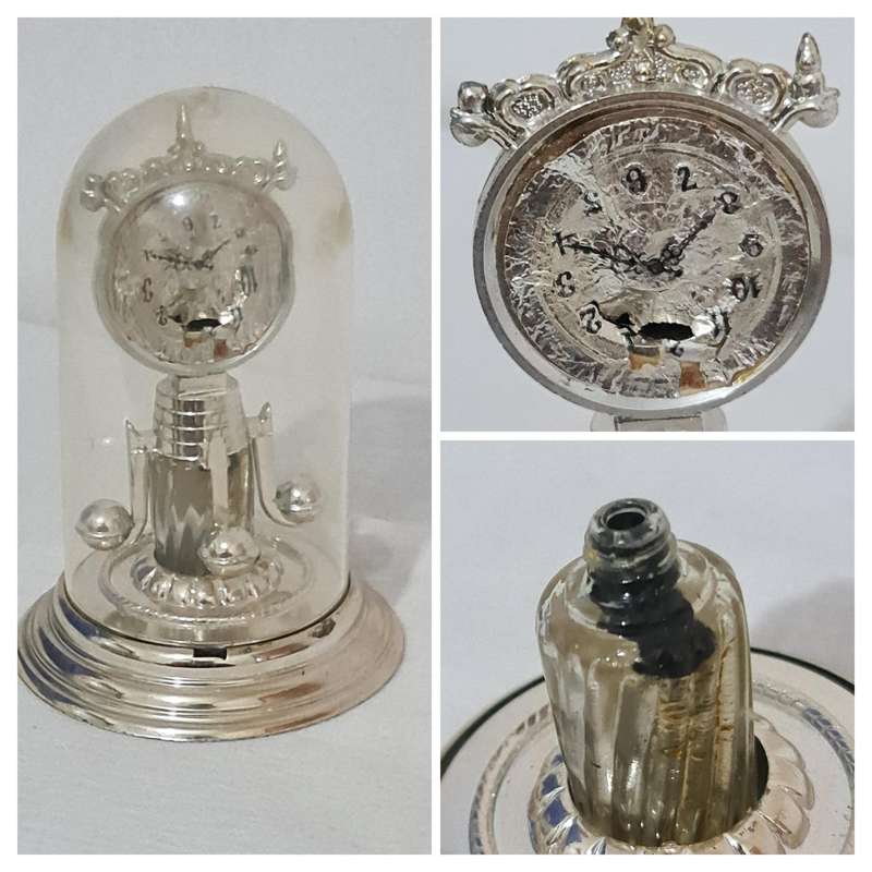 Clock that is not a clock. Small scent bottle inside.  Bottle no lid. Dial damage