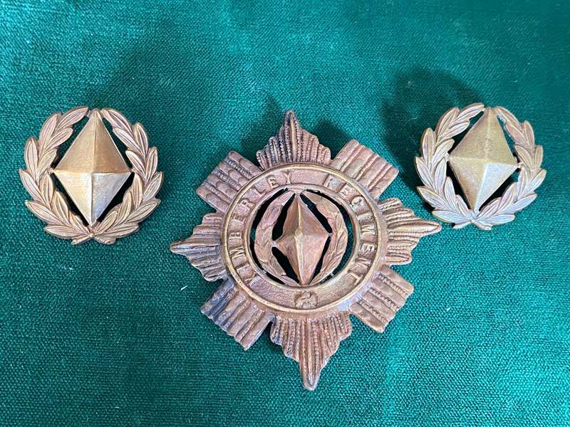 KIMBERLEY REGIMENT BRASS CAP AND COLLARS-WORN 1899-1939-VOIDED CENTRE-ONE LUG ON CAP MISSING