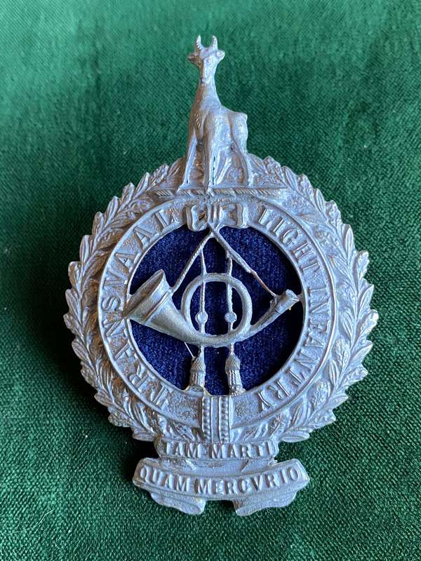 TRANSVAAL LIGHT INFANTRY WHITE METAL AND BLUE FELT HELMET BADGE-WORN 1903-1907- 2 LUGS