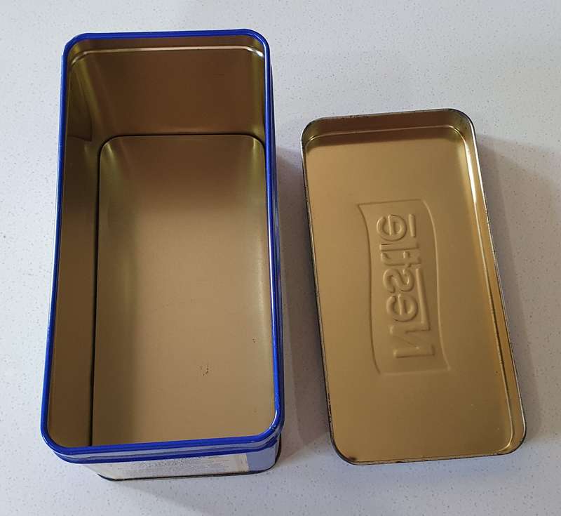 NESTLE tin as per photos