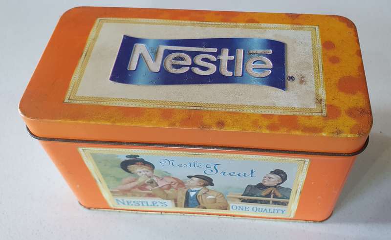 NESTLE tin as per photos
