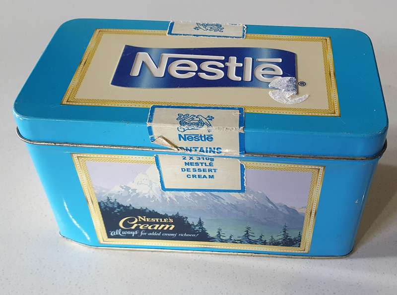 NESTLE tin as per photos