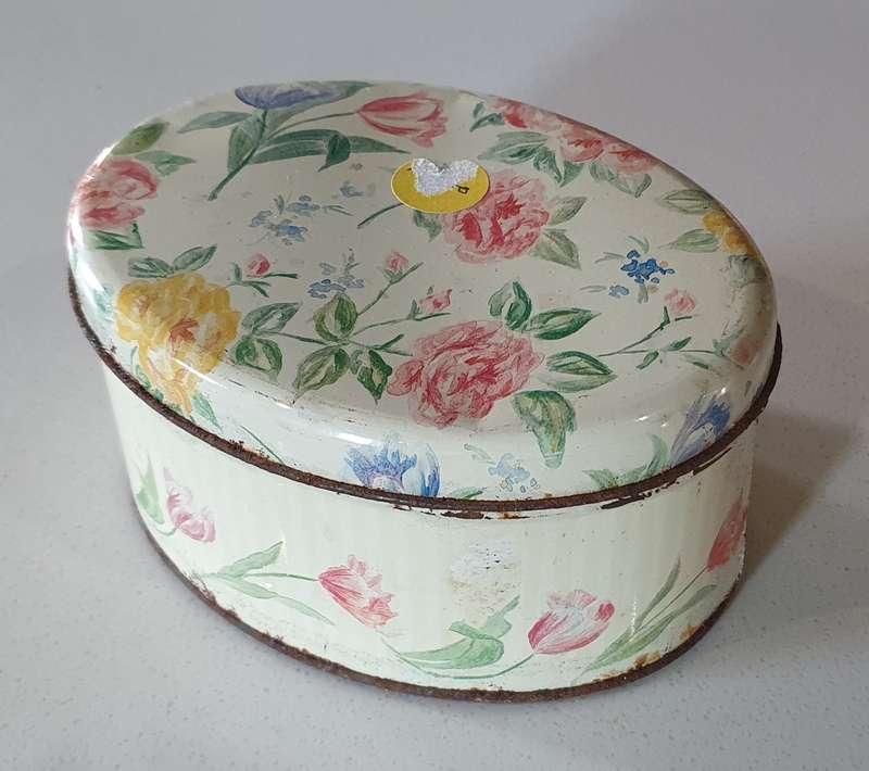 OVAL flower theme tin as per photo.