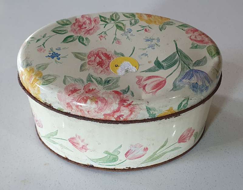 OVAL flower theme tin as per photo.