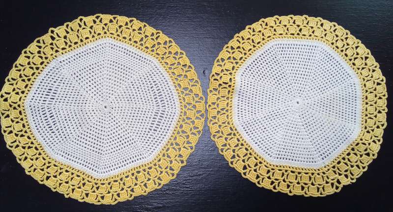 Two charming hand crocheted doilies