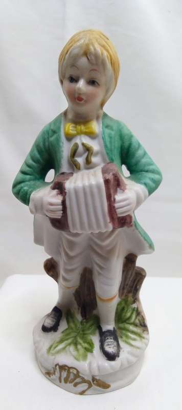 Beautiful vintage figurine boy with accordion