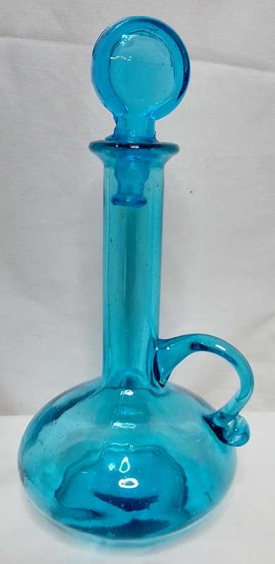 Beautiful small turquoise glass bottle with stopper