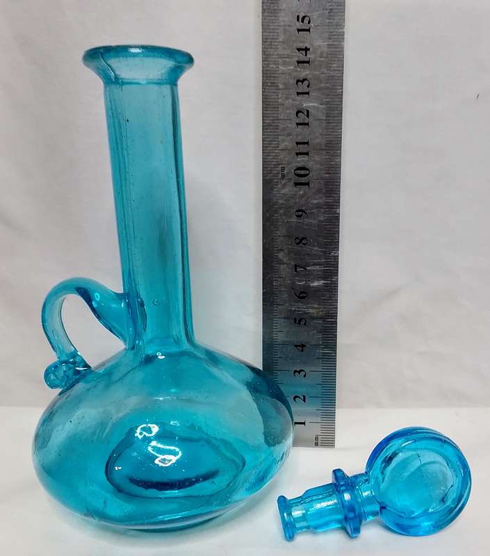 Beautiful small turquoise glass bottle with stopper