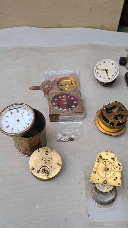 collection of small vintage clock movements for spares or repairs