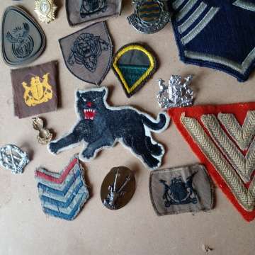 Selection Of Badges Incuding 1st World War Sergeant Badge And 2nd WW Black Cat Badge. Selling As Is