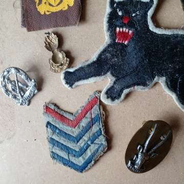 Selection Of Badges Incuding 1st World War Sergeant Badge And 2nd WW Black Cat Badge. Selling As Is