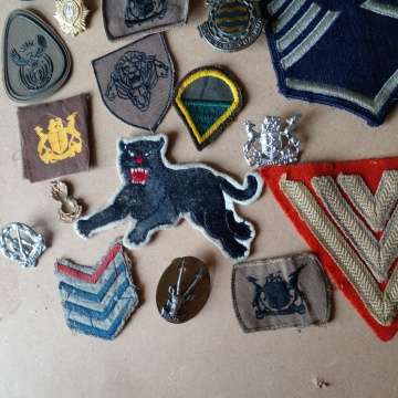 Selection Of Badges Incuding 1st World War Sergeant Badge And 2nd WW Black Cat Badge. Selling As Is