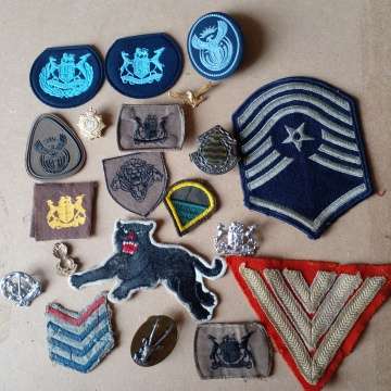 Selection Of Badges Incuding 1st World War Sergeant Badge And 2nd WW Black Cat Badge. Selling As Is